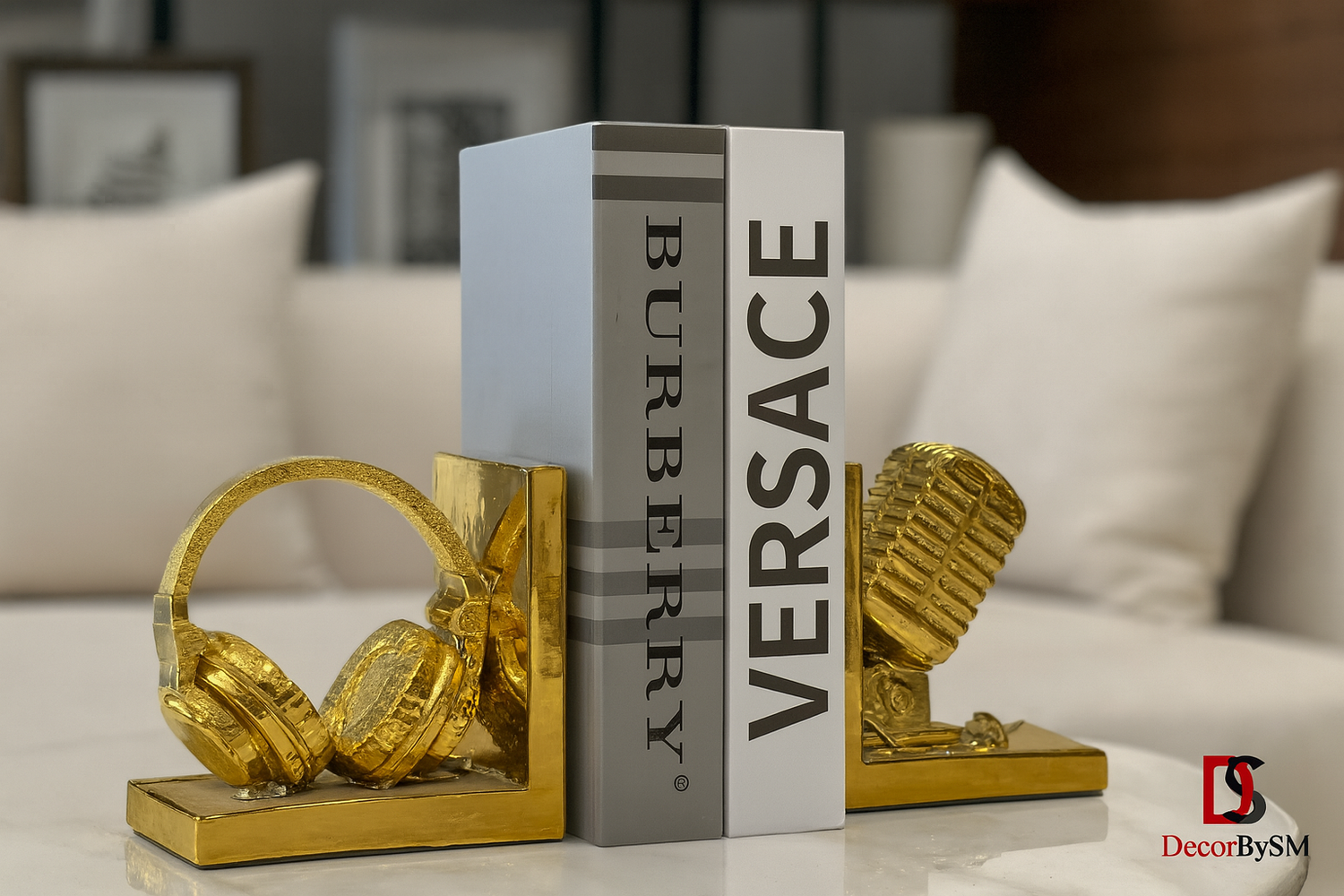 Golden bookends with headphones and microphone on modern white coffee table
