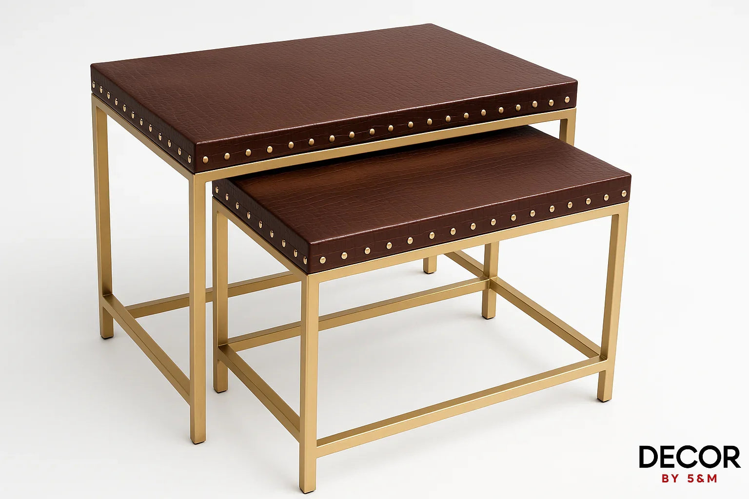 Angled view of leather top nesting tables on white background