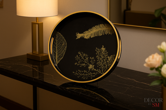 Black and gold botanical serving tray on console