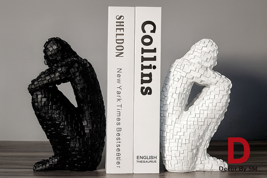 Black and white textured bookends with books on dark wood surface