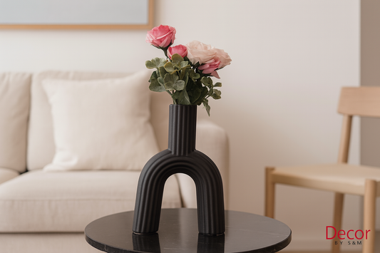 Black arch vase with roses on table in minimal interior
