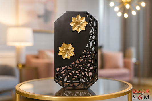 Black geometric lantern with golden flowers on glass table in contemporary living space