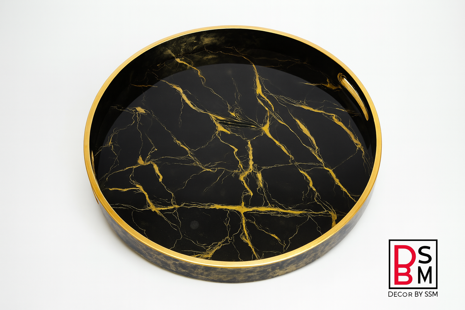 Black marble-effect serving tray with golden rim on white background