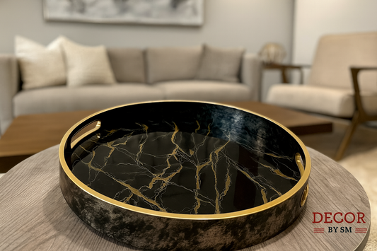 Black marble-effect serving tray with golden veining on modern center table