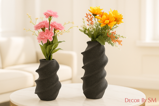 Black twisted sculptural vases with light background