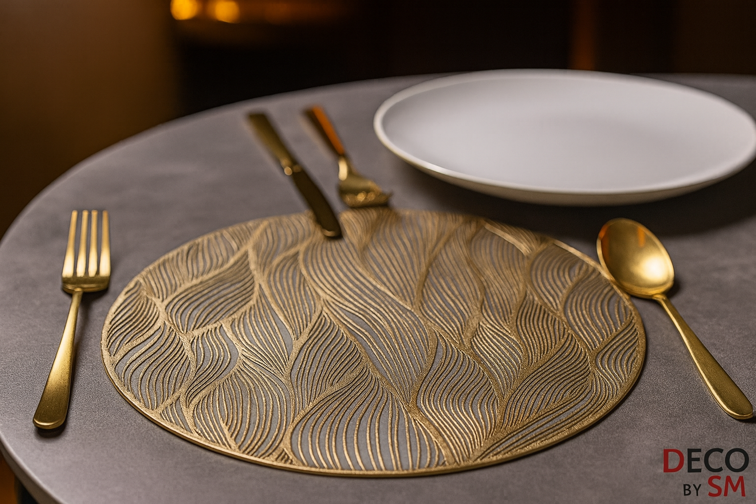 Circular table mat with flowing leaf pattern and gold cutlery on dining table