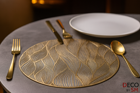 Circular table mat with flowing leaf pattern and gold cutlery on dining table