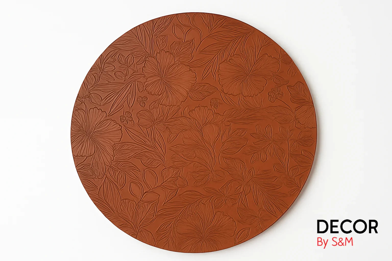 Copper plate with intricate floral engravings on white background
