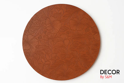 Copper plate with intricate floral engravings on white background