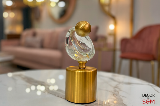 Decorative crystal and gold ornament on glass coffee table in modern living space