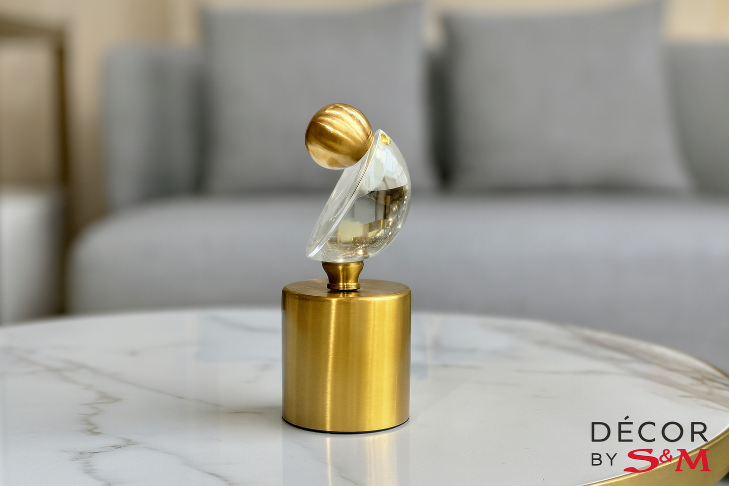 Decorative crystal and gold ornament on white marble table in modern living room