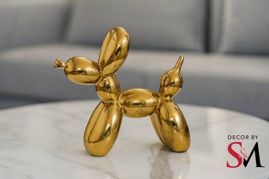 Golden balloon dog sculpture on modern coffee table in contemporary living space