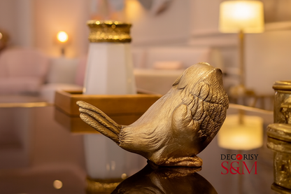 Golden bird figurine with spread wings on glass table in contemporary living space