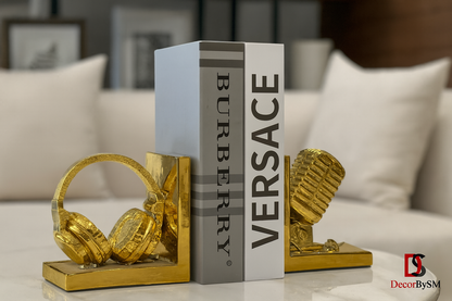 Golden bookends with headphones and microphone on modern white coffee table