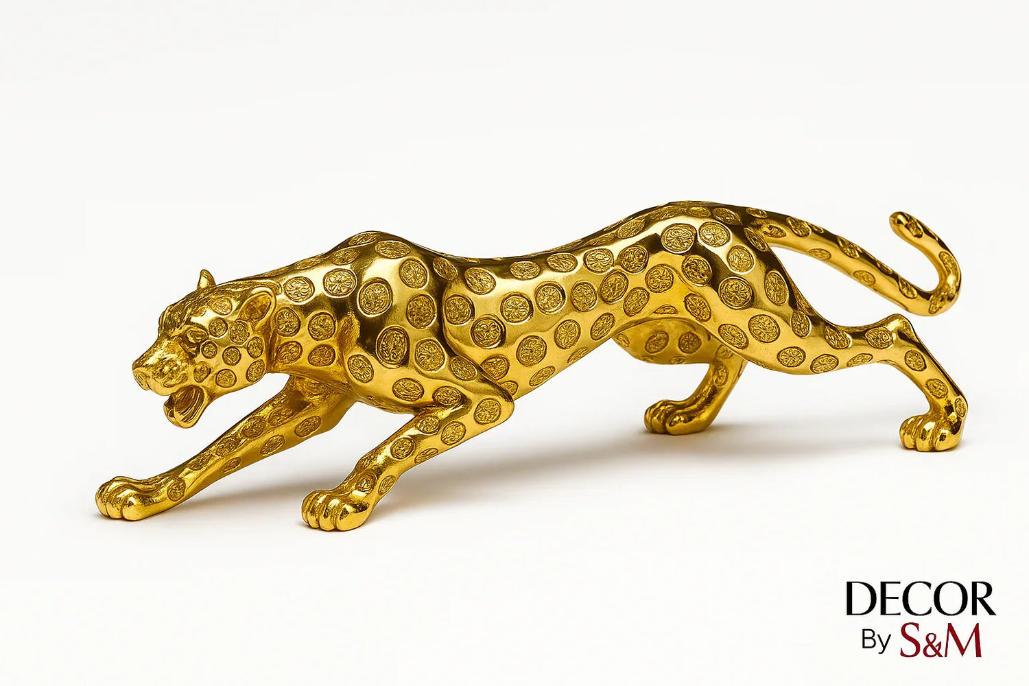 Golden leopard figurine in leaping pose on white background