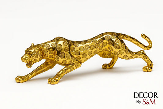 Golden leopard figurine in leaping pose on white background