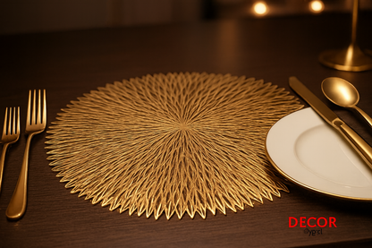 Golden sunburst pattern table mat with gold cutlery on dining table