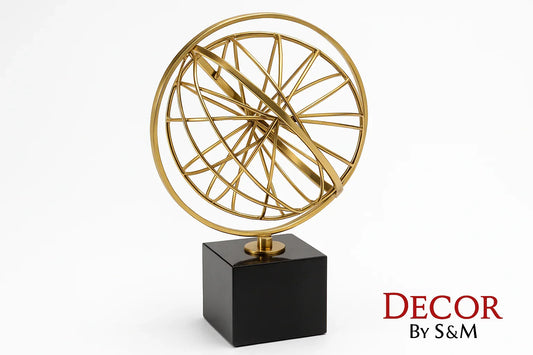 Golden wireframe sphere sculpture on black base with white background