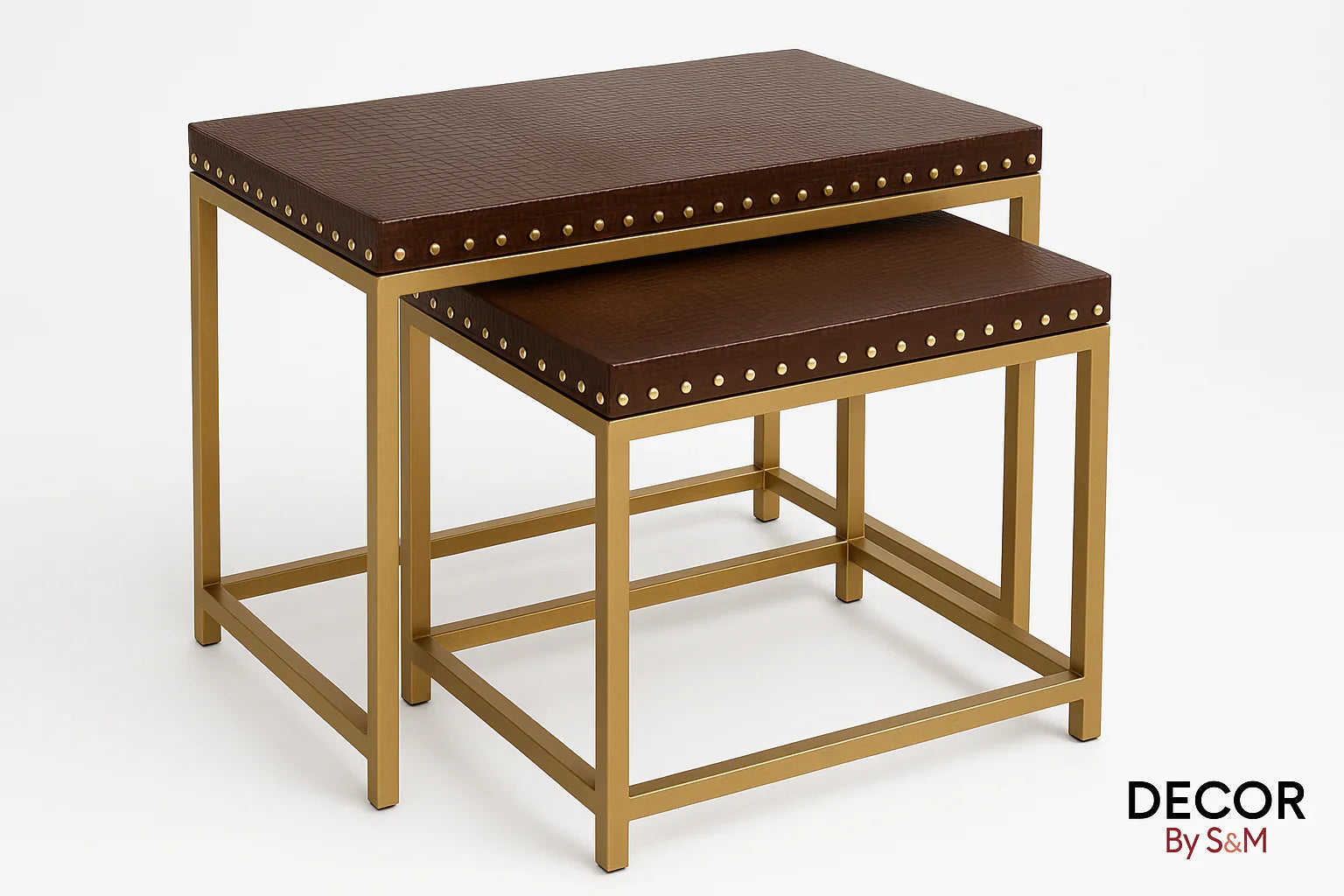 Leather top nesting tables with gold studs and frames on white background