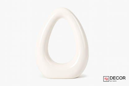 Modern abstract ceramic sculpture with vertical opening on white background
