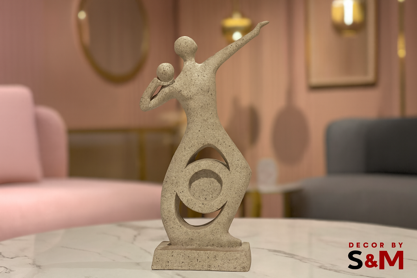 Modern abstract sculpture with figures on glass table in contemporary living space