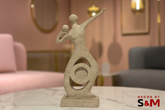 Modern abstract sculpture with figures on glass table in contemporary living space