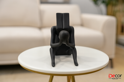 Modern black contemplative figure on white side table in contemporary living space