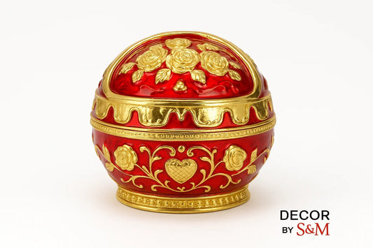 Ornate red and gold decorative egg with intricate patterns on white background