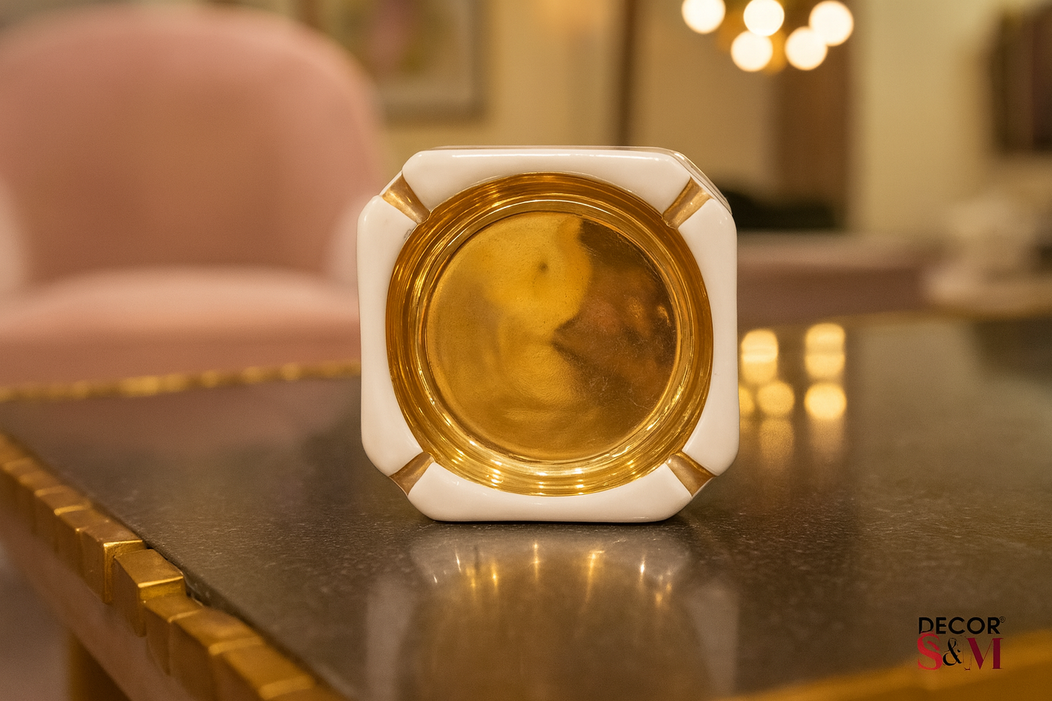 White and gold octagonal decorative bowl on glass table in contemporary living space