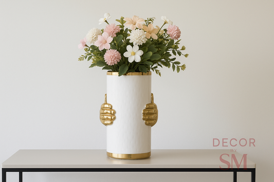 White ceramic vase with golden hand handles on console